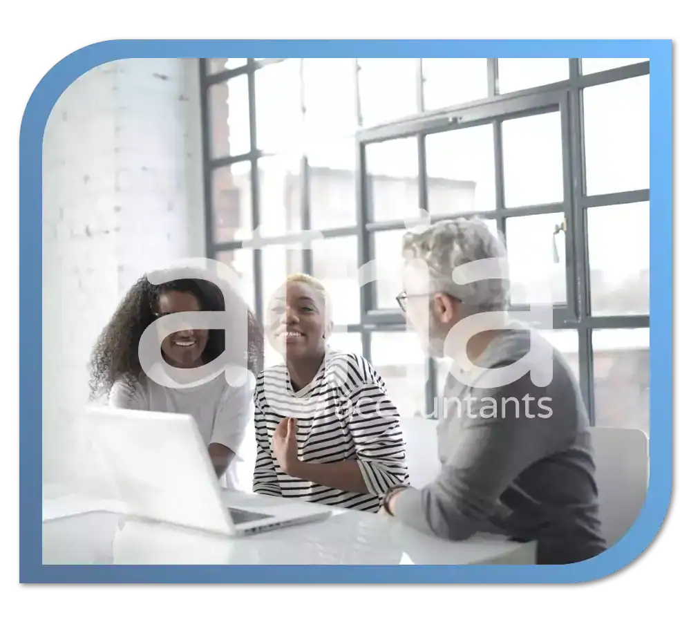 3 office workers in a meeting with Atria Accountants in Bury